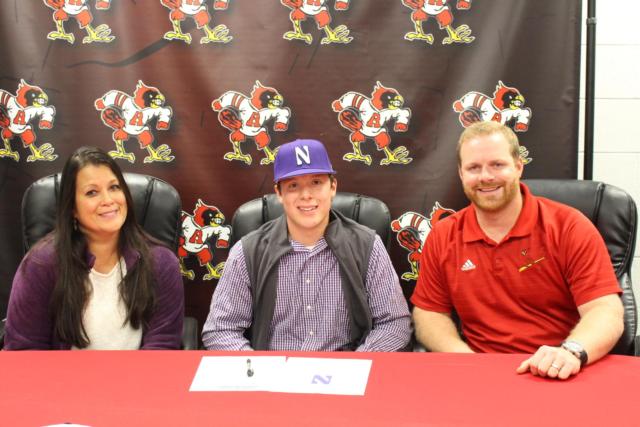 Nick Cauley and his mother, Rebecca and AHS Baseball Coach Todd Haug celebrate the young athlete's signing with Northwestern University. 