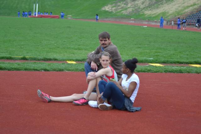 Alton track and field star LaJarvia Brown and Katie Mans have a conversation with Katie's father during the high jump in Wednesday's Alton freshman-sophomore relays. Brown was one of the people who coordinated the high jump in the meet. (Photo by Dan Brannan)