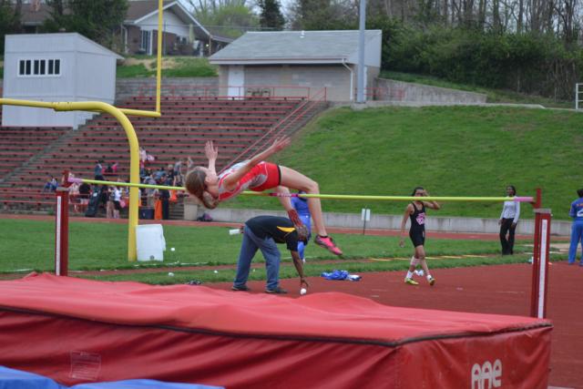 Alton's Katie Mans clears a height on Wednesday in the high jump at Public School Stadium. (Photo by Dan Brannan)