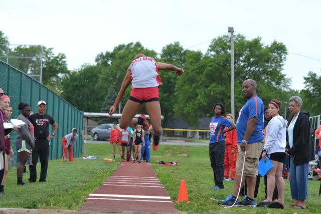 Alton's LaJarvia Brown soars through the air in the long jump at the O'Fallon Sectional on Friday. She qualified in three individual events for the state meet next weekend. (Photo by Dan Brannan)