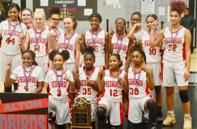The Alton Junior Lady Redbirds celebrate winning the 7th grade 4A IESA state championship at Brooks Middle School on Thursday night.