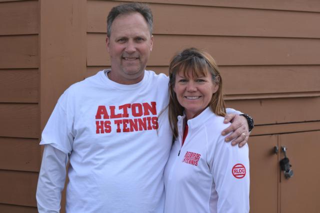 Edwardsville High School tennis coach Dave Lipe is shown with Robert Logan's mother prior to the Edwardsville-Alton tennis match Tuesday. Lipe is wearing a shirt in memory of Logan, the Alton boys tennis coach, who died last September.