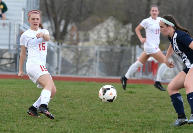 The Redbirds No. 15 Katie Kercher delivers a kick, while teammate Brianna Hatfied trails to the left. Hatfield led the Redbirds with two goals on Monday. (Photo by Dan Brannan)