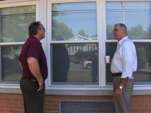 Senior Services Plus Executive Director Jonathan Becker (left) showcases some of SSP's new windows to Mayor Tom Hoechst.